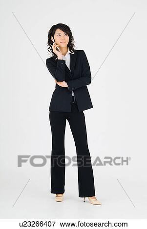 Young woman holding mobile phone View Large Photo Image Stock Photo - Young woman holding mobile phone. Fotosearch
