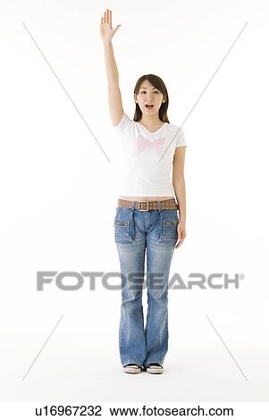 Stock Image - Young woman holding up hand. Fotosearch