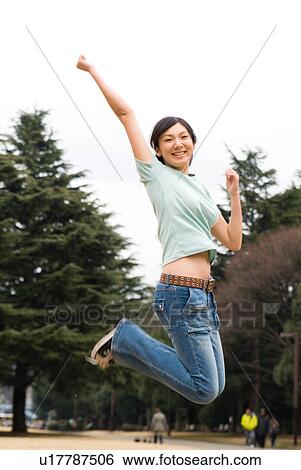 Young woman jumping View Large Photo Image Stock Photograph - Young woman jumping. Fotosearch