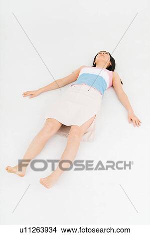 Picture - Young woman lying down. Fotosearch