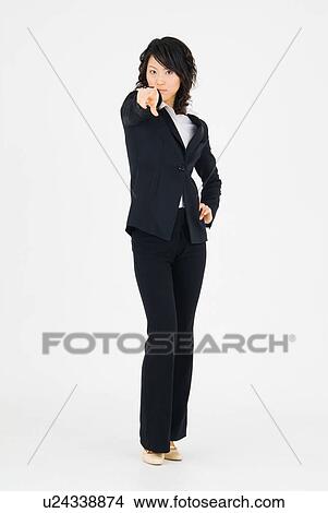 Picture - Young woman pointing straight ahead. Fotosearch