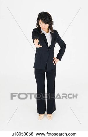 Young woman pointing straight ahead View Large Photo Image Stock Photo - Young woman pointing straight ahead. Fotosearch
