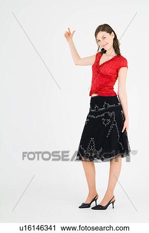 Young woman pointing up View Large Photo Image Stock Image - Young woman pointing up. Fotosearch