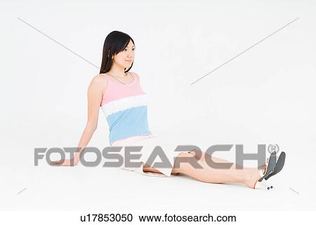 Young woman sitting on floor View Large Photo Image Stock Image - Young woman sitting on floor. Fotosearch