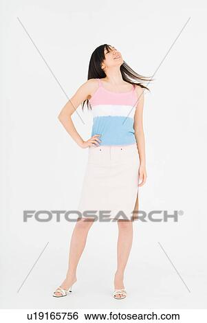 Stock Photograph - Young woman standing. Fotosearch