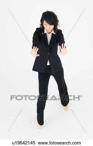 Stock Photography - Young woman standing with arms outstretched. Fotosearch