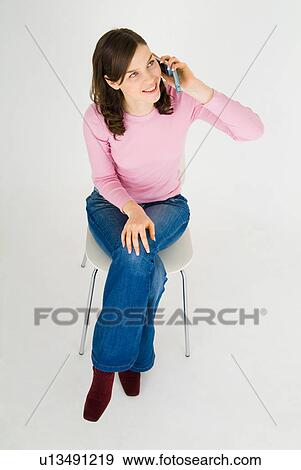 Young woman talking on mobile phone View Large Photo Image Stock Photo - Young woman talking on mobile phone. Fotosearch