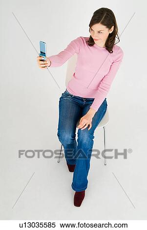 Stock Photography - Young woman using mobile phone. Fotosearch