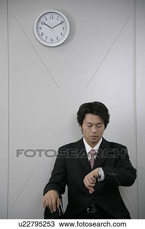 A mid adult man checking watch View Large Photo Image Stock Image - A mid adult man checking watch. Fotosearch