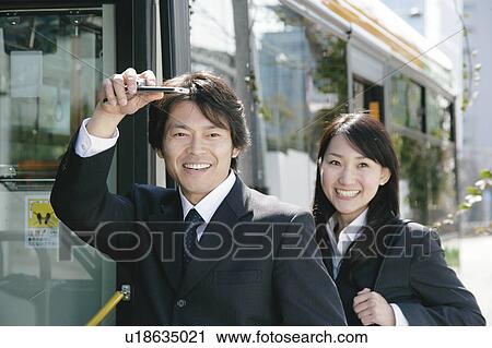 A young woman and a mid adult man getting on a bus View Large Photo Image Stock Image - A young woman and a mid adult man getting on a bus. Fotosearch