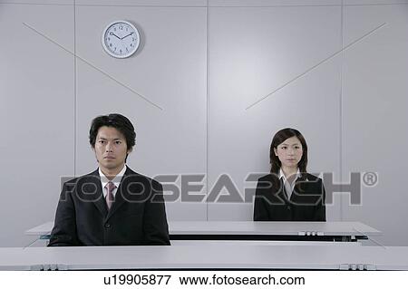 A young woman and a mid adult man sitting in a room View Large Photo Image Stock Photo - A young woman and a mid adult man sitting in a room. Fotosearch