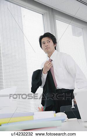 Mid adult man adjusting tie View Large Photo Image Stock Image - Mid adult man adjusting tie. Fotosearch