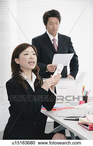 Young woman answering phone and calling somebody View Large Photo Image Stock Image - Young woman answering phone and calling somebody. Fotosearch