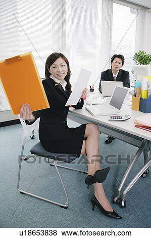 Young woman giving document to somebody View Large Photo Image Stock Photo - Young woman giving document to somebody. Fotosearch