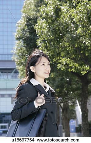 Young woman in suit standing View Large Photo Image Picture - Young woman in suit standing. Fotosearch