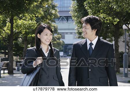 A mid adult businessman and a young businesswoman talking View Large Photo Image Stock Photo - A mid adult businessman and a young businesswoman talking. Fotosearch