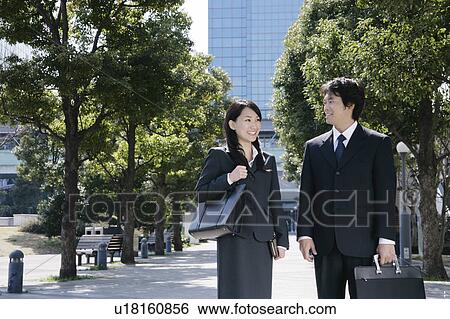 A mid adult businessman and a young businesswoman talking View Large Photo Image Stock Photograph - A mid adult businessman and a young businesswoman talking. Fotosearch