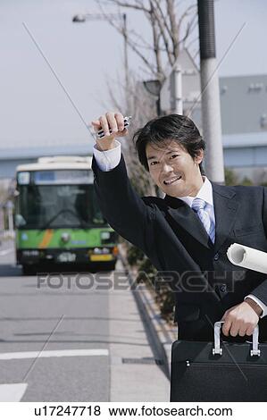 Stock Photo - A mid adult businessman calling somebody. Fotosearch
