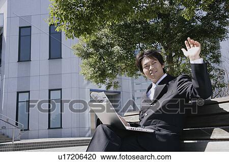 A mid adult businessman raising a hand View Large Photo Image Stock Image - A mid adult businessman raising a hand. Fotosearch
