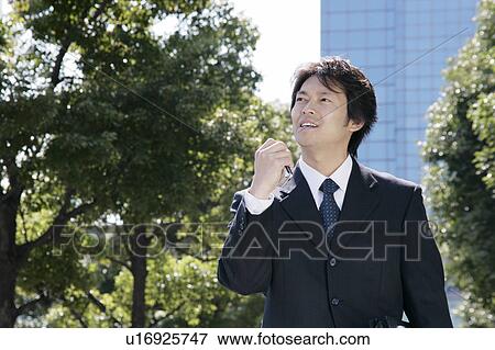Stock Photo - A mid adult businessman smiling. Fotosearch