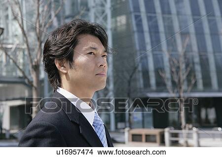 A mid adult businessman standing View Large Photo Image Picture - A mid adult businessman standing. Fotosearch