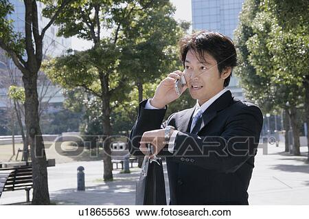 A mid adult businessman talking over mobile phone View Large Photo Image Stock Image - A mid adult businessman talking over mobile phone. Fotosearch