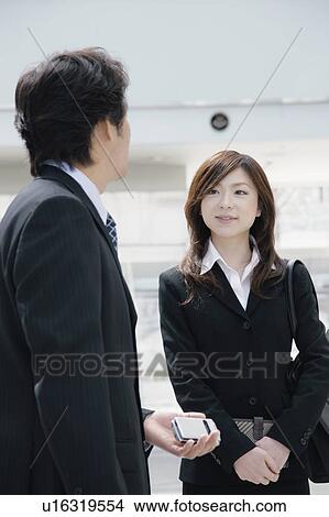 A young woman and a mid adult man talking View Large Photo Image Picture - A young woman and a mid adult man talking. Fotosearch
