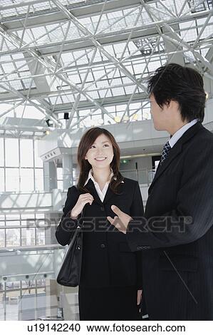 A young woman and a mid adult man talking View Large Photo Image Stock Image - A young woman and a mid adult man talking. Fotosearch