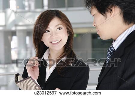 A young woman and a mid adult man talking View Large Photo Image Stock Photo - A young woman and a mid adult man talking. Fotosearch