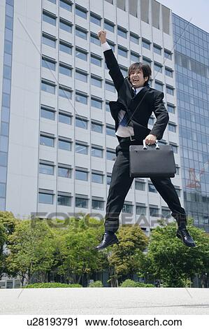 A young man in suit jumping View Large Photo Image Stock Image - A young man in suit jumping. Fotosearch