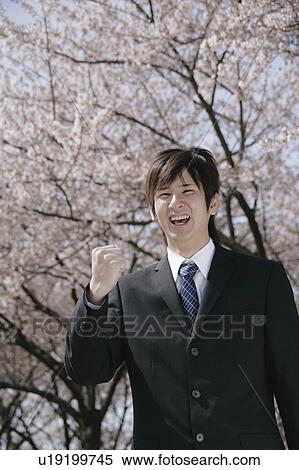 Stock Photography - A young man in suit smiling. Fotosearch