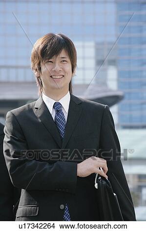 A young man in suit walking View Large Photo Image Picture - A young man in suit walking. Fotosearch