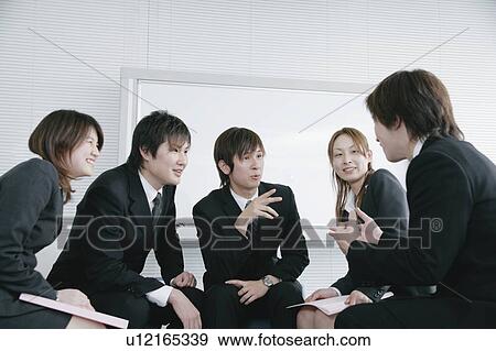 Stock Photo - Five young businessperson discussing. Fotosearch
