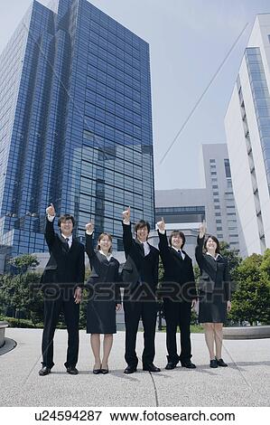 Stock Photo - Five young businessperson pointing ahead. Fotosearch