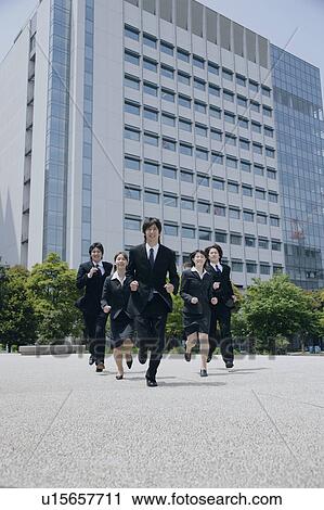 Stock Image - Five young businessperson running. Fotosearch