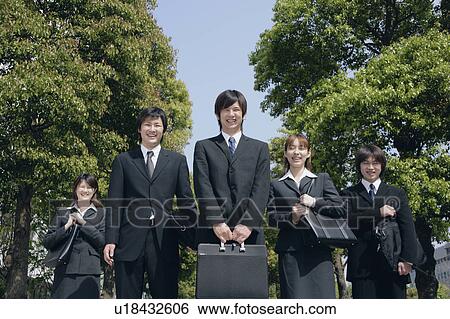Stock Photograph - Five young businessperson smiling. Fotosearch