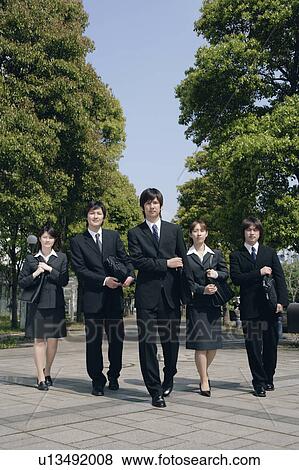 Five young businessperson walking View Large Photo Image Stock Photo - Five young businessperson walking. Fotosearch