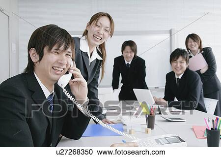 Stock Image - Five young businessperson working. Fotosearch