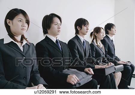 Stock Image - Five young people waiting for job interview. Fotosearch