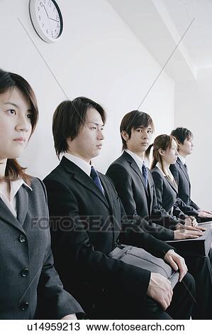 Stock Image - Five young people waiting for job interview. Fotosearch