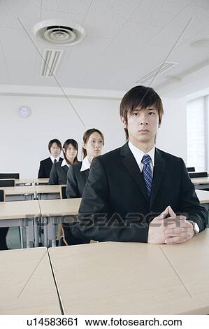 Four young people sitting in a meeting room View Large Photo Image Stock Image - Four young people sitting in a meeting room. Fotosearch