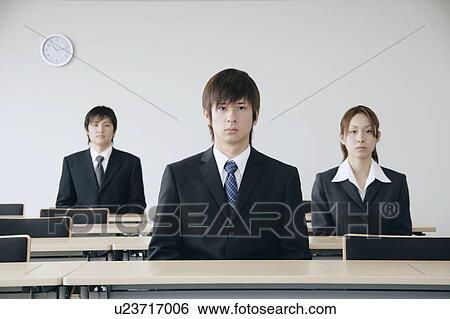 Three young people sitting in a meeting room View Large Photo Image Stock Photograph - Three young people sitting in a meeting room. Fotosearch
