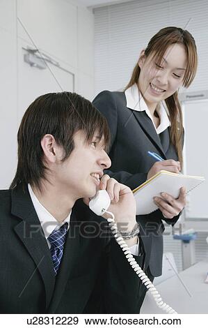 Two young businessperson working View Large Photo Image Stock Photo - Two young businessperson working. Fotosearch