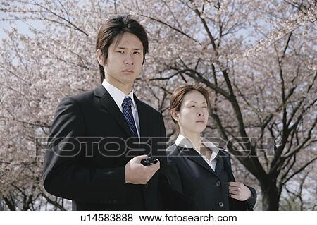 Young woman and man in suit standing View Large Photo Image Stock Photo - Young woman and man in suit standing. Fotosearch