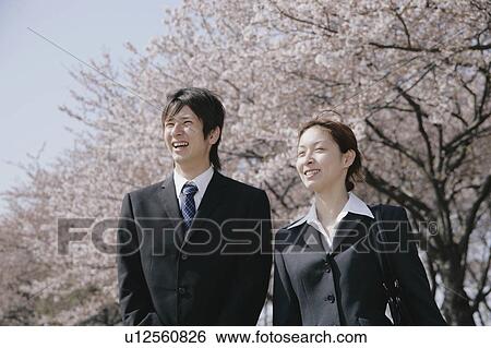 Young woman and man in suit standing View Large Photo Image Stock Photograph - Young woman and man in suit standing. Fotosearch