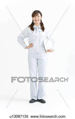 Stock Photography - A female construction worker standing. Fotosearch