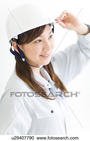 A female construction worker wearing a hardhat View Large Photo Image Stock Image - A female construction worker wearing a hardhat. Fotosearch