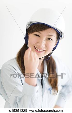 A female construction worker wearing a hardhat View Large Photo Image Stock Photo - A female construction worker wearing a hardhat. Fotosearch