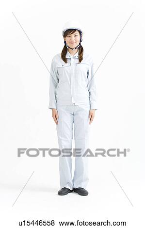 Stock Photo - A female construction worker wearing a hardhat. Fotosearch