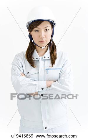 A female construction worker wearing a hardhat View Large Photo Image Stock Photo - A female construction worker wearing a hardhat. Fotosearch